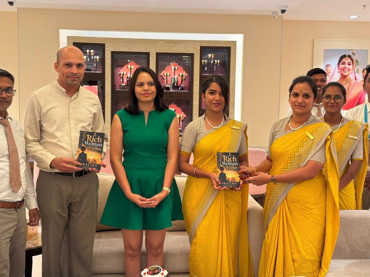 Pratima at a book distribution event with readers holding The Rich Woman Within